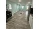 Open kitchen featuring appliances, sleek cabinets, and laminate flooring and a rear door at 4715 Normal Ave, Indianapolis, IN 46226
