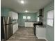 Open kitchen featuring stainless steel appliances, sleek cabinets, and laminate flooring at 4715 Normal Ave, Indianapolis, IN 46226