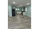 Open kitchen featuring modern appliances, sleek cabinets, and laminate flooring at 4715 Normal Ave, Indianapolis, IN 46226