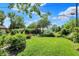 Spacious backyard featuring lush lawn, garden beds, and mature trees for relaxing outdoor living at 4770 Willow Rd, Zionsville, IN 46077