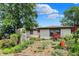 Backyard with garden beds, mature trees and flowers offers tranquility and charm at 4770 Willow Rd, Zionsville, IN 46077