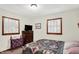 Bright bedroom with natural light and a classic wood-trimmed window, completed with a quilt-covered bed at 4770 Willow Rd, Zionsville, IN 46077