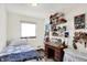 Craft bedroom filled with supplies, and a cozy day bed next to a bright window at 4770 Willow Rd, Zionsville, IN 46077