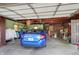 Spacious garage featuring a blue Honda Civic with overhead storage and natural light at 4770 Willow Rd, Zionsville, IN 46077