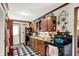 Cozy kitchen featuring black and white checkered flooring, wood cabinets, and ample counter space at 4770 Willow Rd, Zionsville, IN 46077