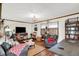 Cozy living room featuring warm wood trim and flooring, comfortable seating, and a decorative light fixture at 4770 Willow Rd, Zionsville, IN 46077
