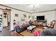 Comfortable living room featuring wood flooring, sofa, mounted television, and unique decorative accents at 4770 Willow Rd, Zionsville, IN 46077