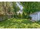 Spacious backyard featuring mature trees, a storage shed, and a well-maintained lawn at 5126 Hillside Ave, Indianapolis, IN 46205