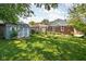 Spacious backyard featuring a storage shed, lush green lawn, and a well-maintained garden at 5126 Hillside Ave, Indianapolis, IN 46205