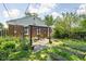 A backyard with a brick patio, pergola, and garden beds is ideal for relaxation and landscaping at 5126 Hillside Ave, Indianapolis, IN 46205