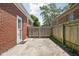 Fenced-in backyard featuring a concrete patio and brick exterior, offering privacy and outdoor space at 5126 Hillside Ave, Indianapolis, IN 46205