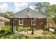 Brick home featuring a cozy backyard patio with a pergola, perfect for outdoor relaxation and entertaining at 5126 Hillside Ave, Indianapolis, IN 46205