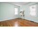 Bedroom with hardwood floors, two windows, and neutral tones offering a serene space at 5126 Hillside Ave, Indianapolis, IN 46205