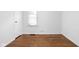 Bedroom with hardwood floors, white walls, and ample closet space at 5126 Hillside Ave, Indianapolis, IN 46205