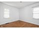 Bright bedroom with hardwood floors and two windows offering natural light at 5126 Hillside Ave, Indianapolis, IN 46205