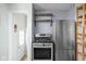 Kitchen with stainless steel appliances, wooden shelving, and access to the backyard at 5126 Hillside Ave, Indianapolis, IN 46205