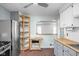 Bright kitchen with stainless steel appliances, wooden shelves, and a view to the other room at 5126 Hillside Ave, Indianapolis, IN 46205