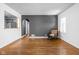 A minimalist living room features hardwood floors, fresh paint, large windows and neutral colors that create an open atmosphere at 5126 Hillside Ave, Indianapolis, IN 46205