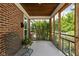A cozy screened in porch offers an inviting space, complemented by a brick wall and outdoor views at 5126 Hillside Ave, Indianapolis, IN 46205