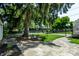 Backyard features mature trees, stone patio, and a glimpse of the neighborhood at 5261 N Pennsylvania St, Indianapolis, IN 46220