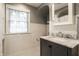Updated bathroom with subway tile, marble vanity, and hexagonal tile flooring at 5261 N Pennsylvania St, Indianapolis, IN 46220