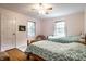 Bright bedroom with two twin beds, hardwood floors, and natural light at 5261 N Pennsylvania St, Indianapolis, IN 46220