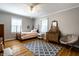 Bedroom with hardwood floors, a bed, a nightstand and a chair at 5261 N Pennsylvania St, Indianapolis, IN 46220