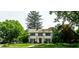 Charming two-story home with a brick facade, manicured lawn, and mature trees at 5261 N Pennsylvania St, Indianapolis, IN 46220