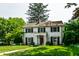 Beautiful two-story home featuring a well-manicured lawn, lovely landscaping, and black window shutters at 5261 N Pennsylvania St, Indianapolis, IN 46220