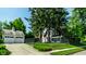 Exterior view of home showcasing the garage, a manicured lawn, and mature trees at 5261 N Pennsylvania St, Indianapolis, IN 46220