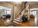 Bright foyer showcasing hardwood floors, an elegant staircase and beautiful views into other rooms at 5261 N Pennsylvania St, Indianapolis, IN 46220