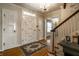 Elegant foyer features hardwood floors, decorative chandelier, and staircase with wooden railing at 5261 N Pennsylvania St, Indianapolis, IN 46220
