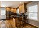 Stylish kitchen island with bar seating, stainless appliances, and hardwood floors at 5261 N Pennsylvania St, Indianapolis, IN 46220