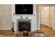 Elegant living room features a fireplace with decorative mantel and hardwood floors at 5261 N Pennsylvania St, Indianapolis, IN 46220