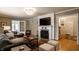 Spacious living room boasts hardwood floors, a stylish fireplace, and a view of the entryway at 5261 N Pennsylvania St, Indianapolis, IN 46220