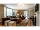 Comfortable living room with bay window, hardwood flooring, fireplace and chandelier lighting at 5261 N Pennsylvania St, Indianapolis, IN 46220