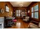 Inviting home office features wood paneling, built-in bookshelves, and an abundance of natural light at 5261 N Pennsylvania St, Indianapolis, IN 46220