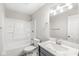 A full bathroom featuring a shower-tub combo with sleek fixtures, vanity and contemporary lighting at 5289 Pine Hill Dr, Noblesville, IN 46062