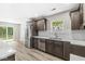 Bright kitchen featuring quartz countertops, stainless steel appliances, and wood-look flooring at 5289 Pine Hill Dr, Noblesville, IN 46062