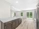 Stylish kitchen island with shaker cabinets, quartz counters, stainless appliances, and slider to back yard at 5289 Pine Hill Dr, Noblesville, IN 46062