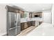 Modern kitchen with stainless steel appliances, shaker cabinets, quartz counters, and wood-look flooring at 5289 Pine Hill Dr, Noblesville, IN 46062