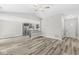 Open-concept living area featuring vaulted ceiling, wood-look floors, and entry to kitchen area at 5289 Pine Hill Dr, Noblesville, IN 46062