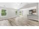 Open-concept living area featuring vaulted ceiling, wood-look floors, slider to backyard and natural light at 5289 Pine Hill Dr, Noblesville, IN 46062