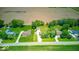 Aerial view of the property showcasing its location near a road, open land, and other homes in the area at 608 W 600 N, Fortville, IN 46040