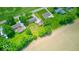 Drone shot of the property showcasing its location near a road, open land, and other homes in the area at 608 W 600 N, Fortville, IN 46040