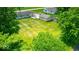 Aerial view of the property and surrounding area with the house, detached garage, and green backyard at 608 W 600 N, Fortville, IN 46040
