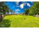 Expansive backyard with lush green grass, mature trees, privacy fence, and detached garage at 608 W 600 N, Fortville, IN 46040