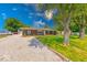 Well-maintained brick home with a gravel driveway, mature trees, and manicured lawn at 608 W 600 N, Fortville, IN 46040