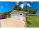 View of the detached two-car garage, driveway, and a section of the well maintained front lawn at 608 W 600 N, Fortville, IN 46040
