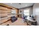 The home office has a unique wood wall and a functional desk setup at 608 W 600 N, Fortville, IN 46040